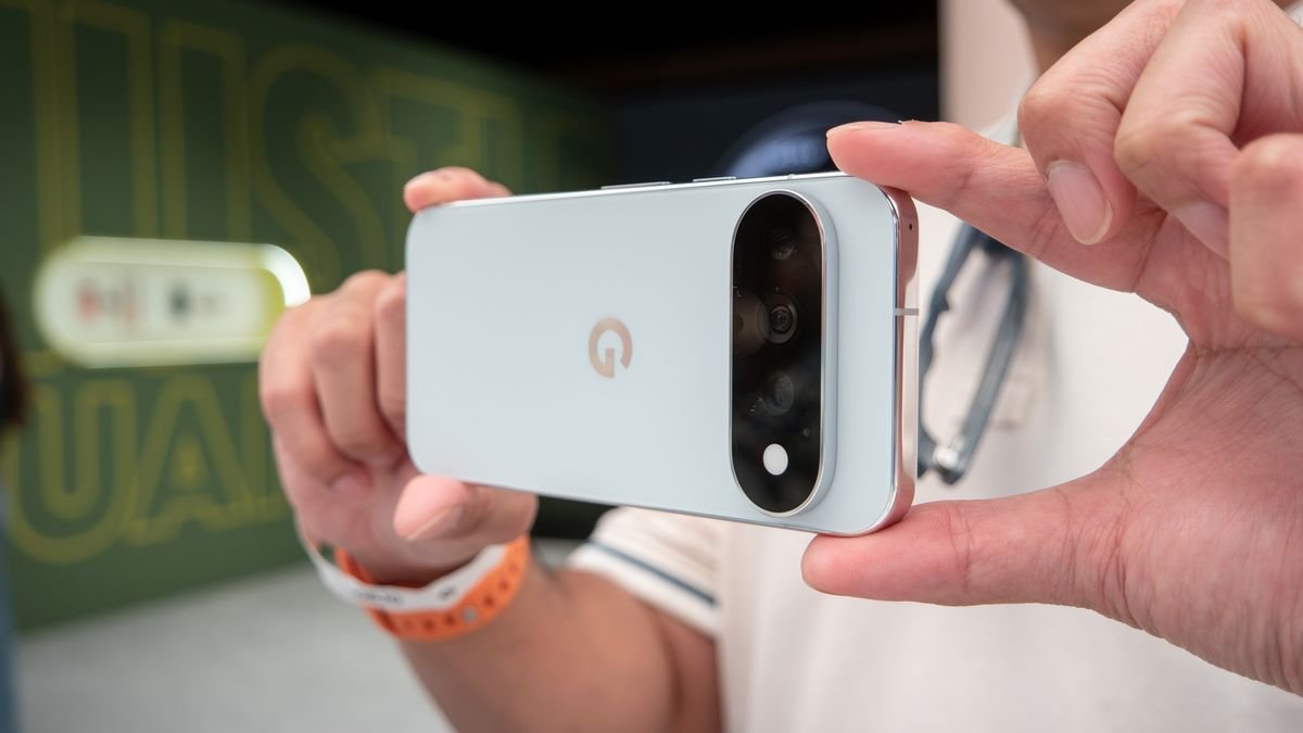 A close-up of a person holding a light blue Google Pixel 11 Pro smartphone horizontally.