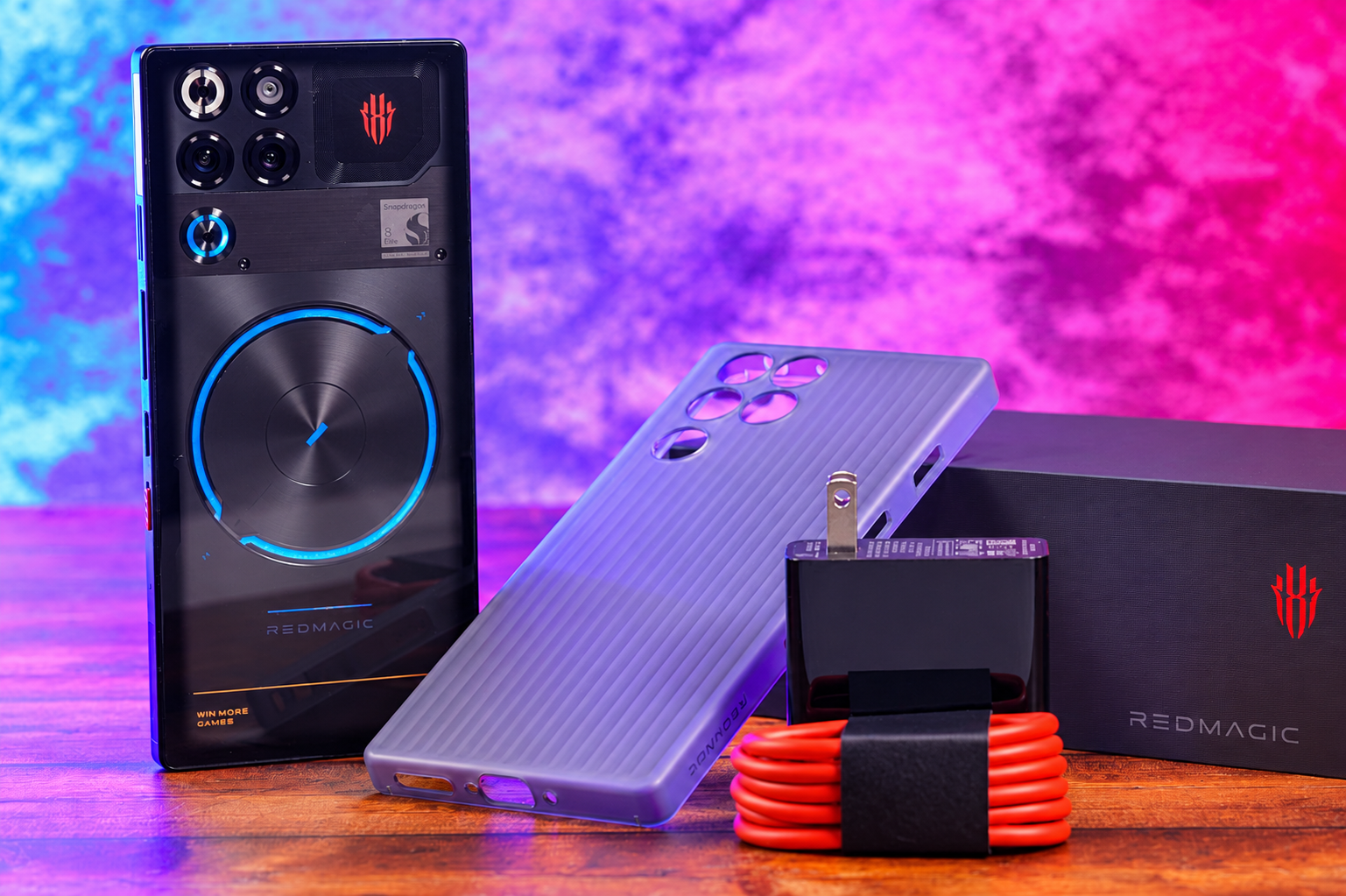 REDMAGIC gaming phone with accessories in a colorful neon-lit setup.